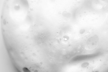 Foam soap abstract background with selective focus. Close up, macro