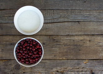 sugar and cherry on a wooden background