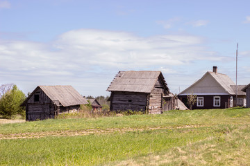Fototapeta na wymiar Complex of old wooden houses in a small village in Lithuania