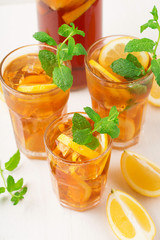 Iced tea with lemon slices, mint and ice