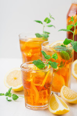 Fototapeta premium Iced tea with lemon slices, mint and ice