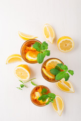 Iced tea with lemon slices, mint and ice