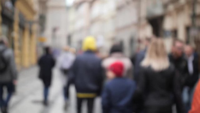 Crowded people street, pedestrian zone. People out of focus. 4K Slow Mo