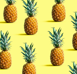 Many pineapples on a solid color background