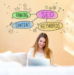 SEO concept with young woman using her laptop computer at home