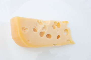 piece of cheese with holes on white background
