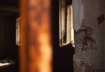 Destroyed room in abandoned building. Sun rays light up messy apocalyptique interior. Decay concept. 