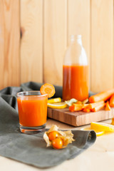Wholesome carrot juice on rustic table