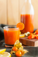 Wholesome carrot juice on rustic table