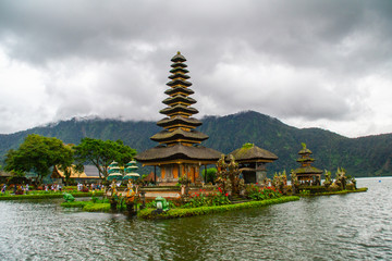 Naklejka premium Moody scenic landscape view of Pura Ulun Danu Bratan, Hindu water temple on Bratan lake, tourist most popular attraction in Bali island, Indonesia.
