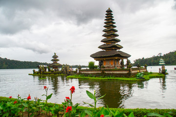 Fototapeta na wymiar Moody scenic landscape view of Pura Ulun Danu Bratan, Hindu water temple on Bratan lake, tourist most popular attraction in Bali island, Indonesia.