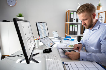 Businessperson Calculating Invoice