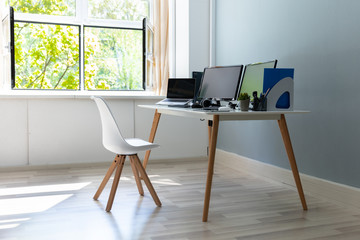 Computer On Desk In Modern Office