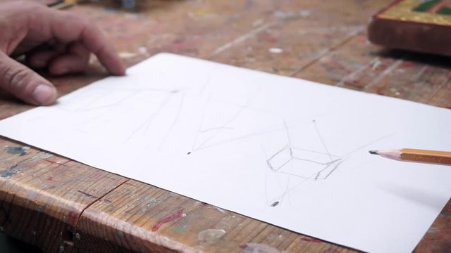 a man drawing some sketches in the studio