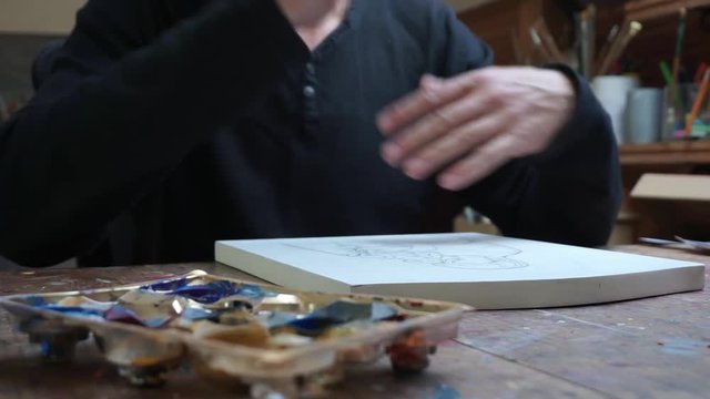 Man takes a pencil, ready to draw,