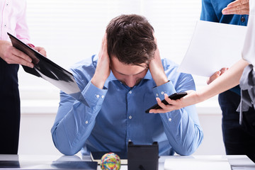 Stressed Businessman Sitting In Office