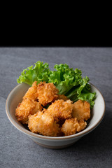 Fried chicken and lettuce in gray bowl on table.
