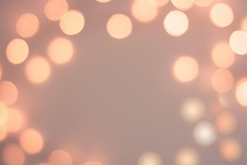 Blurred golden sparkling festive bokeh background. Peach Fuzz, color of 2024 year	