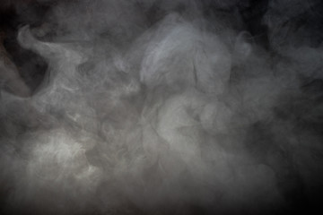 Smoke and dense fog on black background.