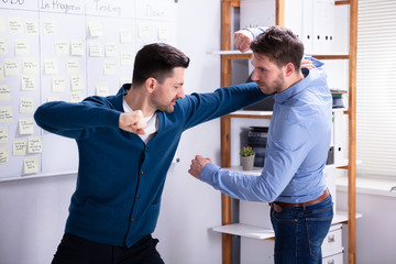 Businessmen Getting Into A Fight Woman Trying To Separate Them
