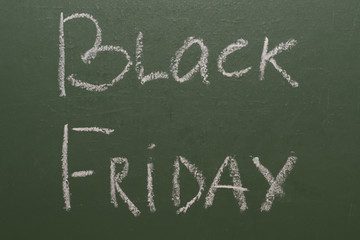 Black Friday handwritten inscription on green chalkboard.