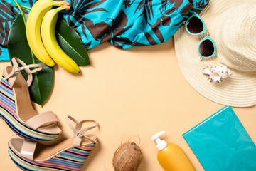 Frame made of summer woman accessories and fruits on yellow background with free space for text. Travel vacation concept. Summer background. Beach frame set. Flat lay style composition, top view.