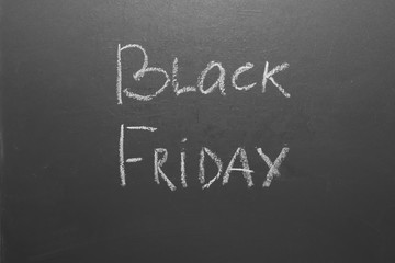 Black Friday handwritten inscription on gray chalkboard.