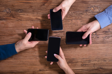 Businesspeople Using Mobile Phones
