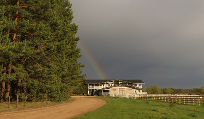 old house on the hill with rainbow