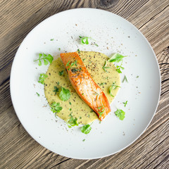 fried fish fillet with fresh garden cress, thyme, rosemary and dry spices in lemon-mustard sauce 