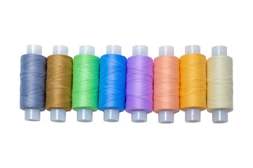 spools of thread and different colors for sewing isolated