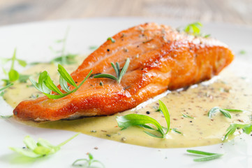 fried fish fillet with fresh herbs and spices in lemon-mustard sauce 