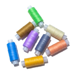 spools of thread and different colors isolated