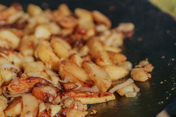 Fried Golden Potatoes on the grill. Cooking food in nature. Cooking food on fire.