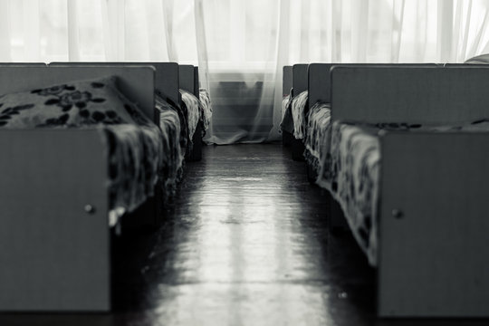 Long room with beds on the sides. Bedroom in the orphanage