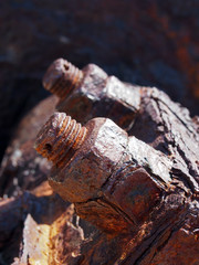 Obraz premium close up of brown rusted threaded bolts and nuts on old corroded machinery