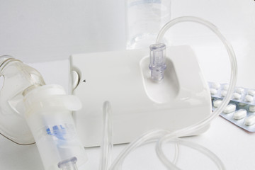  nebulizer and medicines on a white background