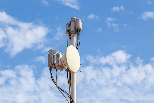 City broadband network technology concept. White high speed mobile Internet transmission antena transmit abstract communication signal. 5g wireless connection of telecommunication infrastructure.