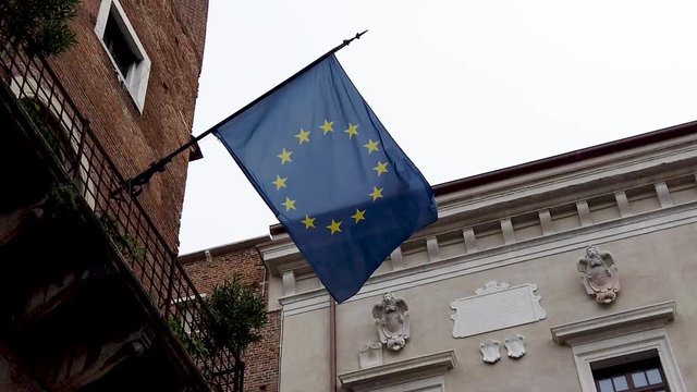 A European flag outside hanging on a building