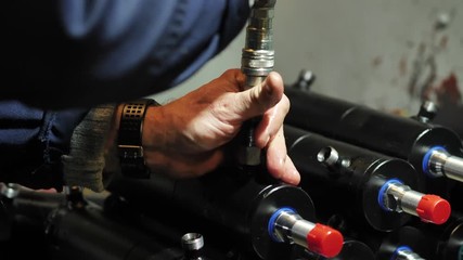 Production of hydraulic cylinders, a worker assembles a close-up pneumatic piston