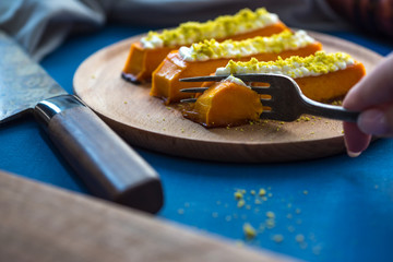 Sweet pumpkin dessert with cream cheese. Healthy tasty eastern food on the plate. sweet dessert with topping.