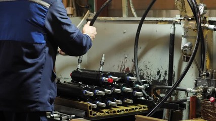 worker assembles pneumatic piston, Production of hydraulic cylinders, a worker assembles