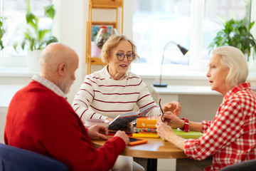 Pleasant smart aged people discussing their favourite books