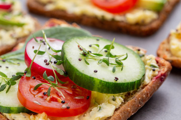 Sandwiches with cream cheese, vegetables and salami.