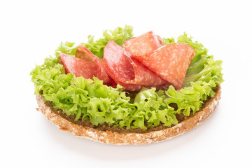 Sandwich with salami sausage on white background.