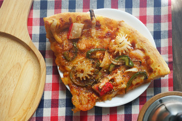 Topview a piece of pizza on the table