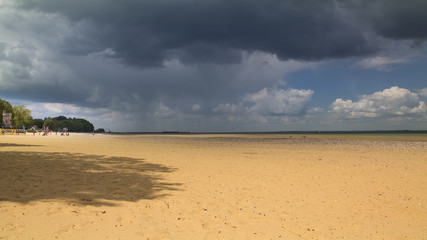 Looming rain clouds over Ryde sands with Appley tower