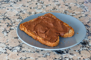 Slice toast with cocoa cream on blue plate
