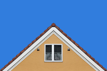 Fototapeta na wymiar modern orange house gable roof design wall with clear blue sky background.