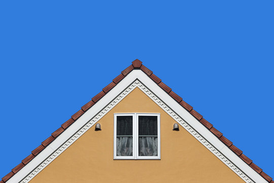 modern orange house gable roof design wall with clear blue sky background.